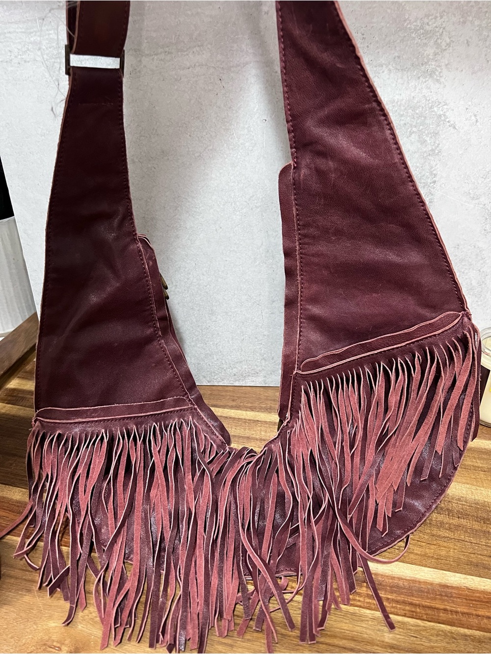 Sash Bag leather fringe crossbody bag in a rich merlot shade, featuring a distin